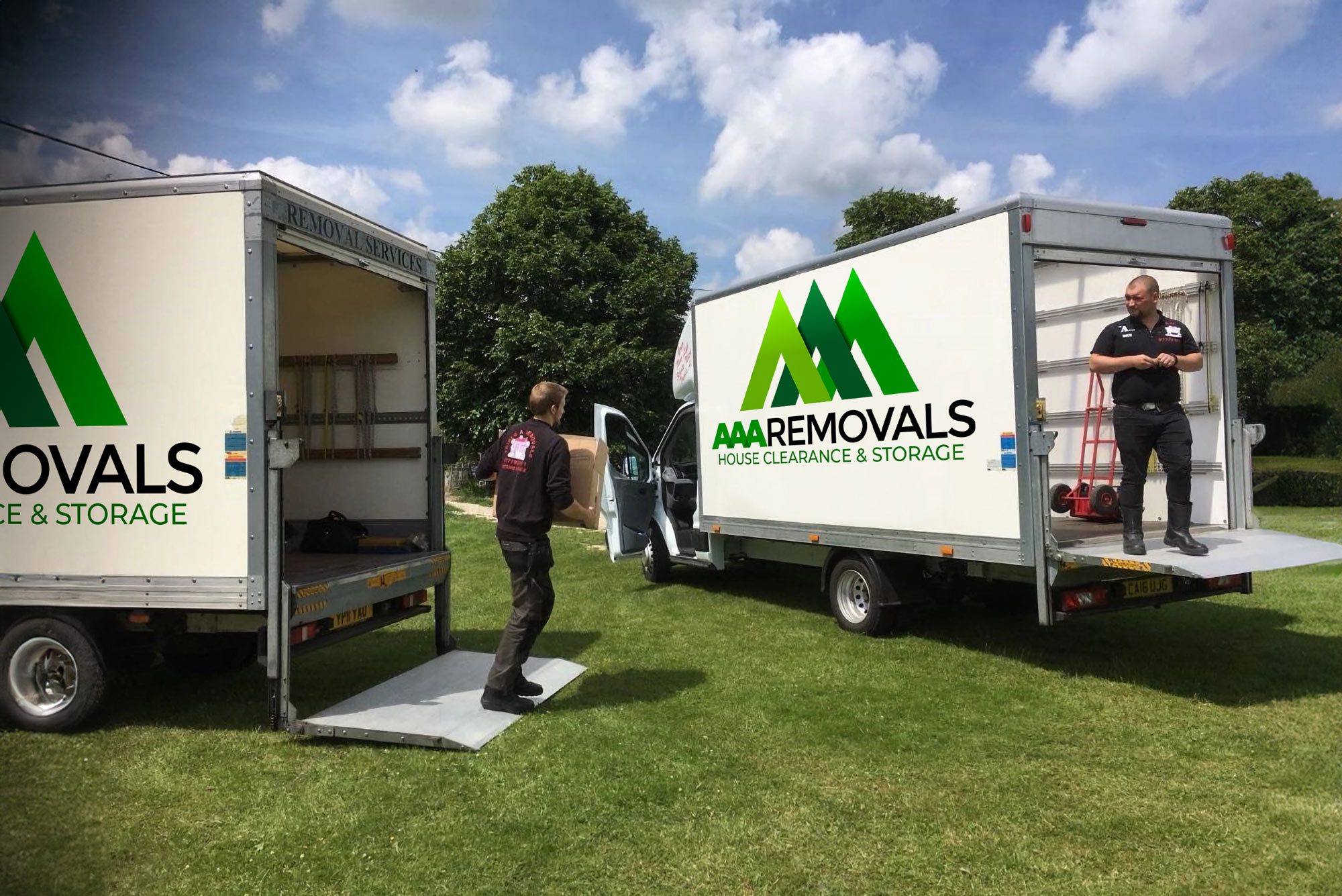 Real photo of AAA Removals branded removal vans with visible logo and service text.